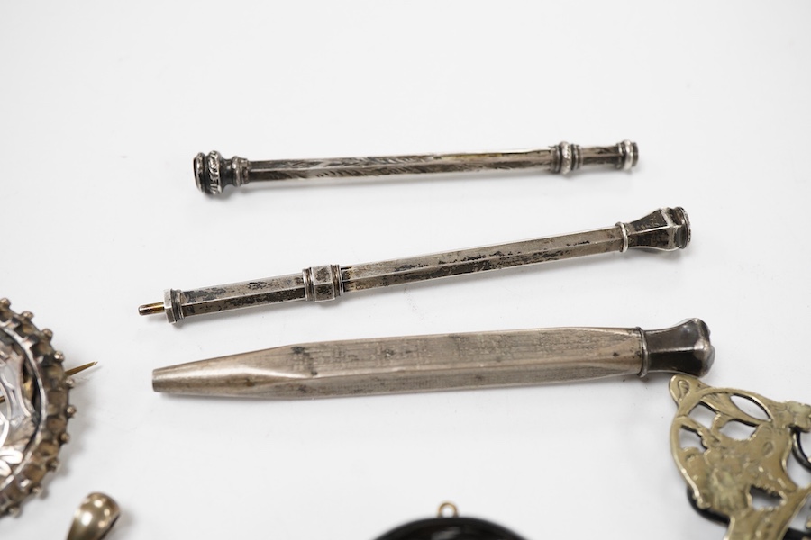 A group of jewellery, comprising: a locket, possibly in jet or bog oak, bearing the initials CIM, the interior with two compartments, length 4.6cm, design registration mark for circa 1861, maker's mark; three mechanical